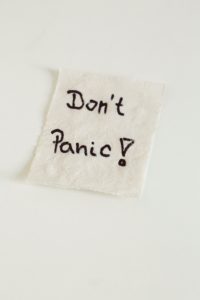 Decorative image of a paper towel with handwritten words don't panic! 